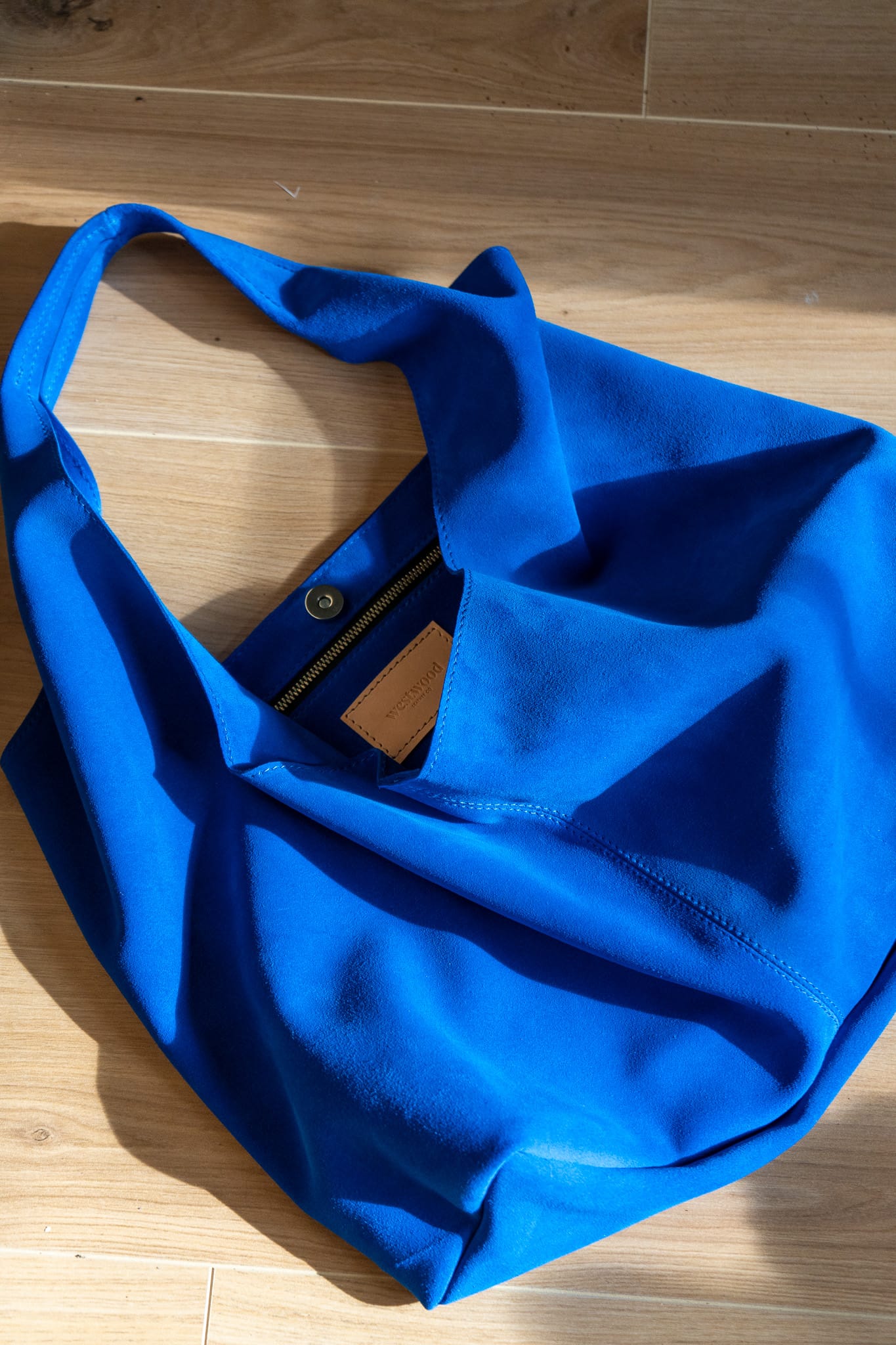 a soft blue tote bag on a wooden background