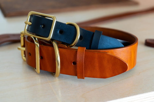 A brown leather belt keeper with a buckle and extra strap loops, showcasing its design and craftsmanship.