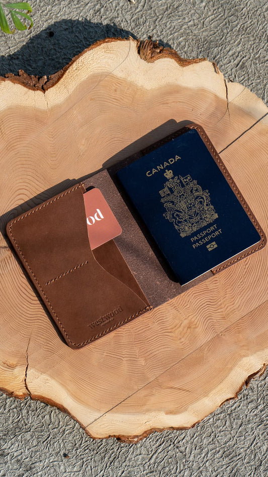 A brown leather passport wallet opened to display the interior card slots and the slot to slide a passport into. A passport is visible inside the wallet.