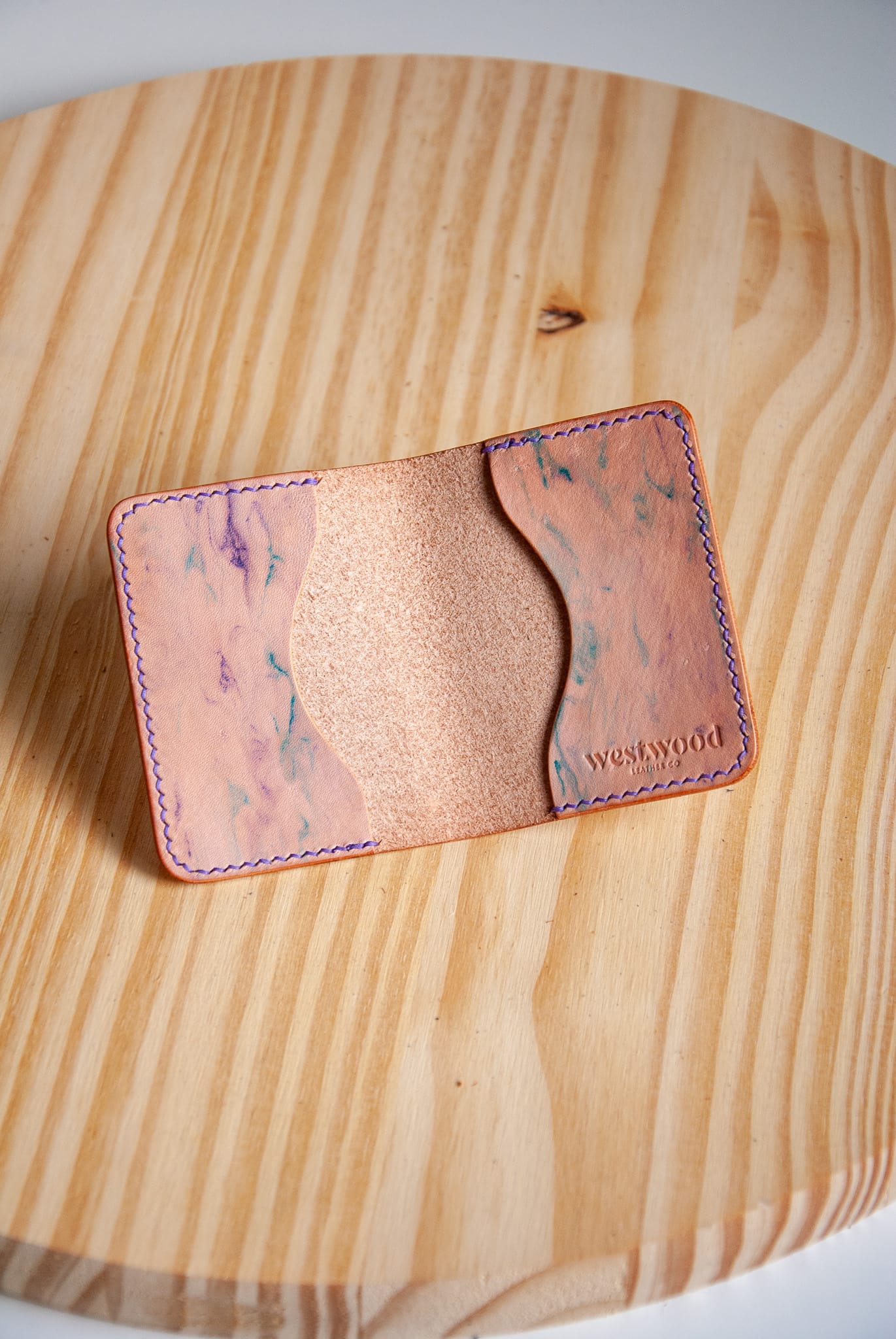 Cardholder with marbled pattern on a wooden surface